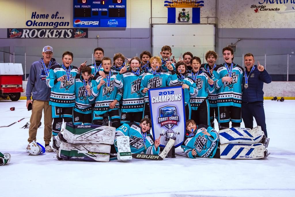 A teal-jerseyed International Cup team lines up on the ice with their championship banner and medals